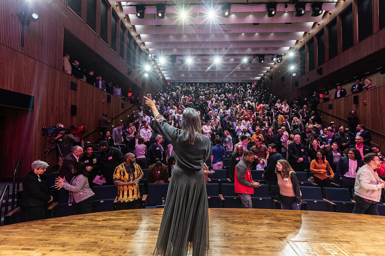 Seema Alexander addressing a packed audience at a keynote event